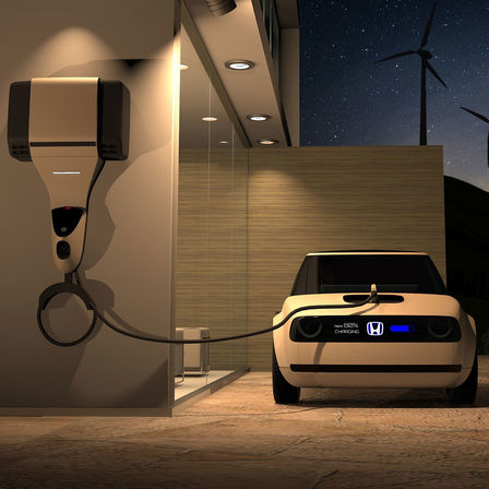 Vue de face de l'intérieur de la Honda Urban EV Concept raccordée à une borne de charge.