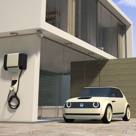 Vue de trois quarts avant de la Honda Urban EV Concept avec borne de charge.