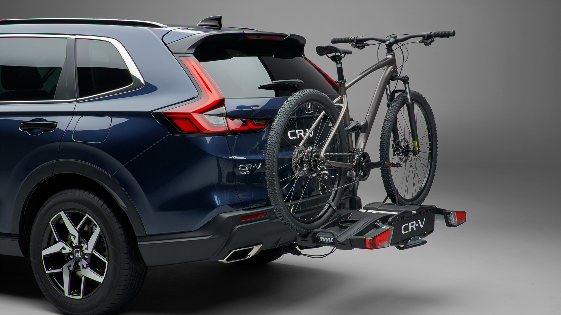 Vue de trois quarts arrière du Honda CR-V Hybrid équipé d’un porte-vélos.