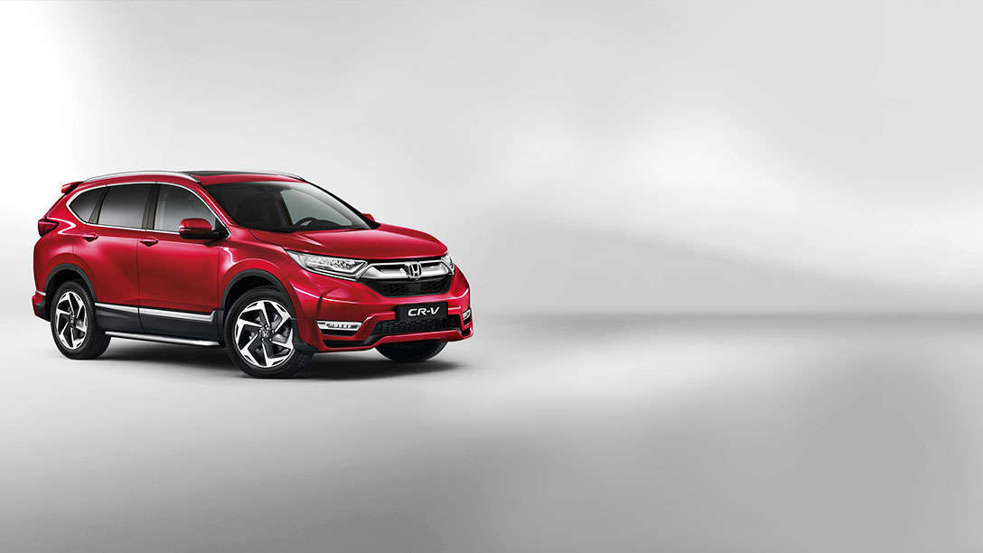 Vue latérale du Honda CR-V rouge en studio.