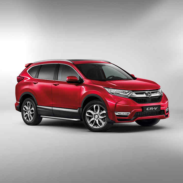 Vue latérale du Honda CR-V rouge en studio.