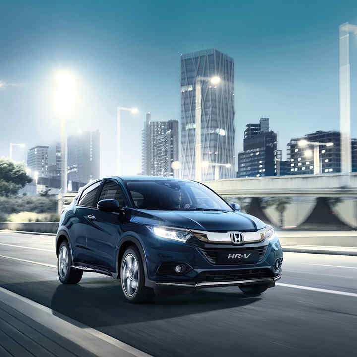 Honda HR-V three-quarter side view in city location.