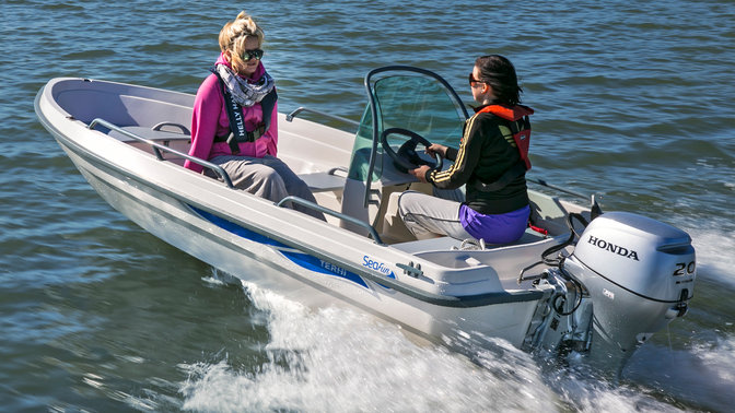 Boat with BF20 engine, being used by models, coastal location.