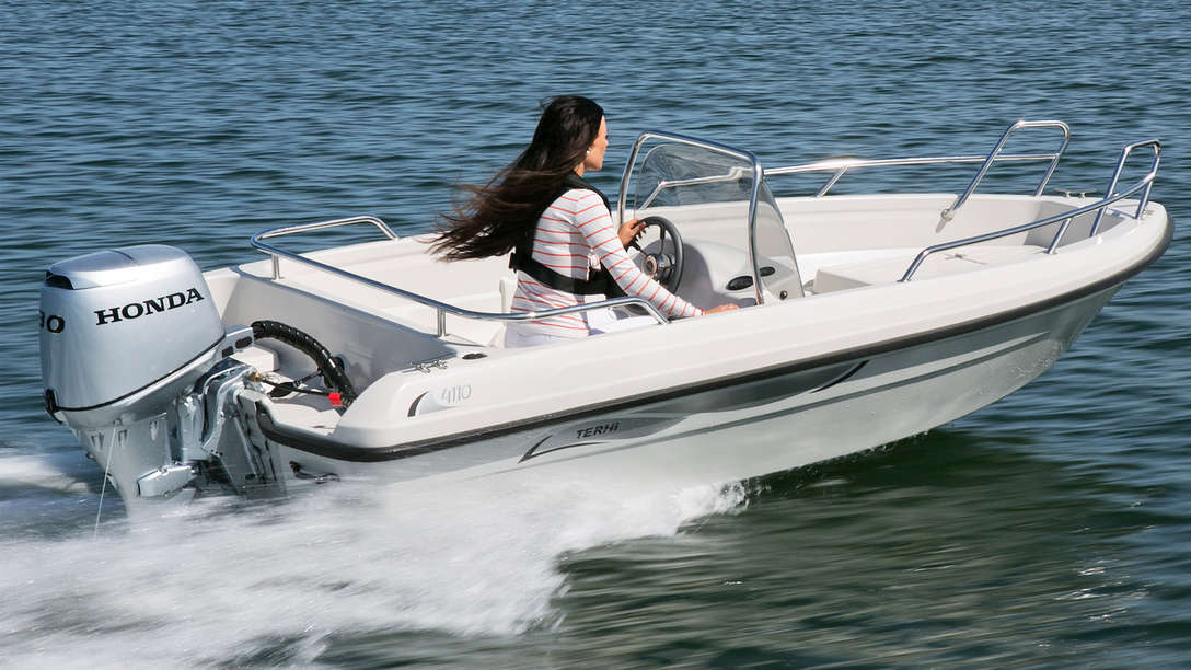 Boat with BF30 engine, being used by model, coastal location.