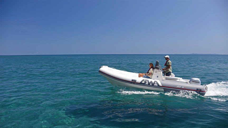 Couple riding an inflatable speed boat with a Honda BF 50 outboard engine